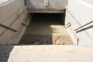 A flooded pedestrian underpass under a highway as a result of a natural disaster. photo