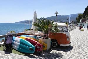 Yalta, Ukraine, July 26, 2021 - longboarding boards for extreme recreation and sports and a vintage Volkswagen car. photo