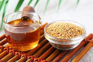 sunflower coking oil and seeds in a container on table photo