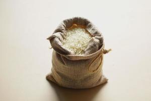 Rice in a bag on table cloth, Top view. photo