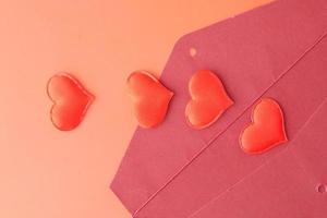 heart shape symbol and envelope on red background photo