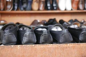 shoes at shelves at local shop in dhaka photo