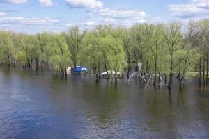 Spring flood on a river in Europe as a result of seasonal snowmelt and groundwater rise, flooding of buildings. photo