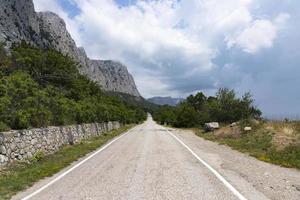 An old European road in the mountains along the rocks. Coast of the Black Sea. photo