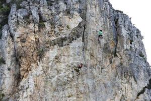 Crimea, Ukraine, July 25, 2021 - A group of children are engaged in rock climbing as a sport on the rocks in the Crimean mountains. photo