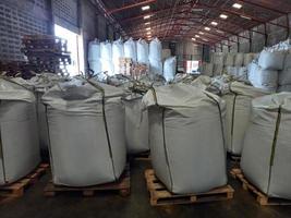 Large jumbo hemp sack White, packed with chemical fertilizer, rice, sugar, placed on a wooden pallet waiting to be delivered to the customer photo