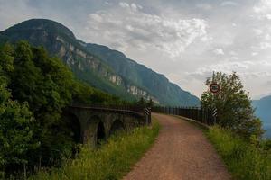 Path following ancient railway, natural landscape in spring, hiking and beaten roads photo