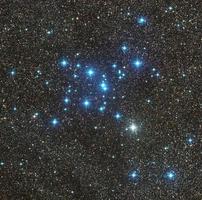 M7 Ptolemy star cluster imaged through Telescope Live's remote robotic telescopes, starry and bright environment with blue stars above photo