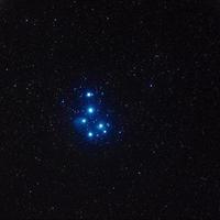 Pleiades star cluster imaged through Telescope Live's remote robotic telescopes, deep blue stars united together in dark space photo