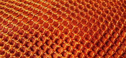 Gold orange honeycomb net patterns backgrpund. Synthetic honeycom net structure fabric background design. Available for text. Suitable for poster, backdrop, presentation, wallpaper, advertising, etc. photo