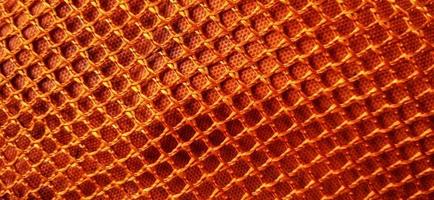 backgrpund de patrones de red de panal naranja dorado. diseño de fondo de tela de estructura de red de nido de abeja sintética. disponible para texto. adecuado para afiches, fondos, presentaciones, fondos de pantalla, publicidad, etc. foto