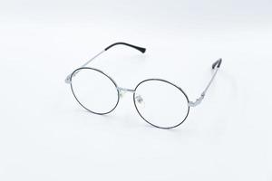 Selective focus round eyeglasses with silver rim. Front left view. Isolated white background. photo