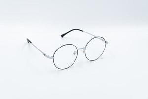 Selective focus round eyeglasses with silver rim. Front right view. Isolated white background. photo