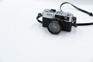 Isolated white background Beautiful vintage analog rangefinder film camera. 70's Decade film camera. Front left view image copy space. photo