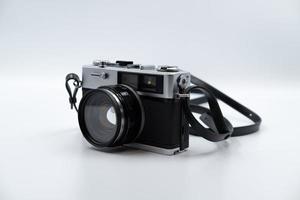 Isolated white background Beautiful vintage analog rangefinder film camera. 70's Decade film camera. Front left view image. photo