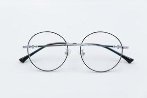 Selective focus round eyeglasses with silver rim. Isolated white background. photo