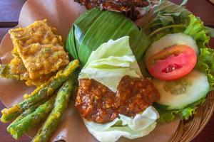 Indonesian specialties rice and ayam geprek and other complementary photo