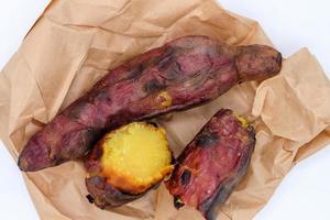 There are Roast sweet potatoes. Japanese Potato are on brown bag. White background. photo