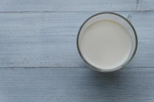 Top view and close up of A glass of fresh milk on wooden background. photo