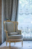 armchair in front of a window interior design photo