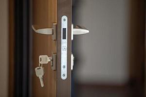 door handle and lock with key in the key hole photo