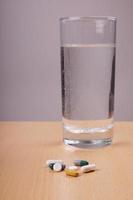 medication pills and water glass photo