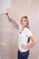 handywoman removing wallpaper photo