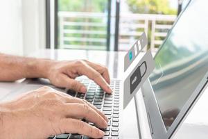 Man typing on keyboard to use computer network. Laptop screen showing login for security system. Concept work at home with computers and Internet. Notebook computer on table. close up, blur background photo