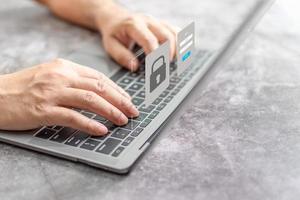 Man typing on keyboard to use computer network. Laptop screen showing login for security system. Concept work at home with computers and Internet. Notebook computer on table. close up, blur background photo