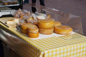 cheese stall at an open-air farmers market photo