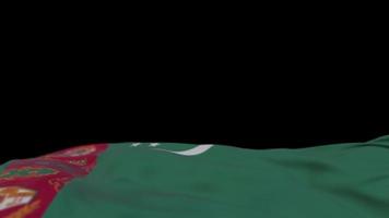 bandera de tela de turkmenistán ondeando en el bucle de viento. Bandera de tela cosida bordada turkmenistani balanceándose con la brisa. fondo negro medio relleno. lugar para el texto. Bucle de 20 segundos. 4k