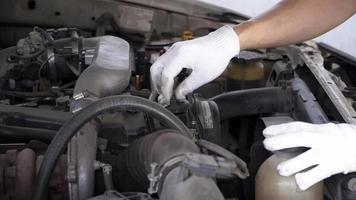 mechanic is closing the oil cap from the car's engine. video