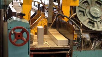 Industrial band saw, cutting metal aluminum, coolant in yellow scene, industrial tools. video