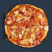Hawaiian Thin Crust Pizza on wood cutting board and place on gray-black background with copy space. Top view. Clipping path. photo
