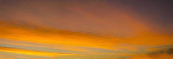 Panorama-The sky is a colorful orange-yellow horizontal line in the beautiful evening in the midst of a peaceful, warm and romantic nature in the countryside and very beautiful. photo