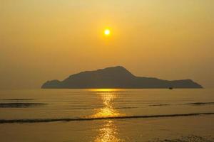 strong wind and ocean waves blow in the evening. The sea floor is light yellow, warm, alternating to see the islands in the sea created by nature, both beautiful and romantic. photo