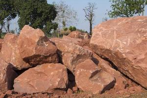 Brown mountain sandstone with large chunks of patterns, designed to be like nature by heavy machinery, beautifully crafted in a vast lakeside garden, perfect for relaxing and watching nature in summer photo