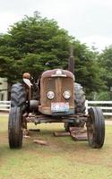 Antique tractors decorated in a beautiful garden in a tourist attraction that is a landmark for tourists to see-8-13-2014-Ratchaburi, Thailand photo