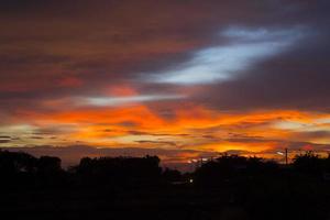 sky is a horizontal, yellow orange Line and many colors in the beautiful evening colors in the tranquil, warm, and romantic nature in the countryside. photo