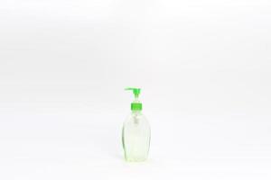 Isolated green alcohol gel bottle and pump on white background. photo