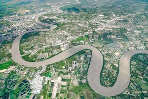 Beautiful Curve River was shot on the plane in the noon. It can see farming and valley all around. photo