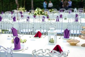 Luxury White - Purple - Red Dinner table set with Crystal chair in the garden. photo