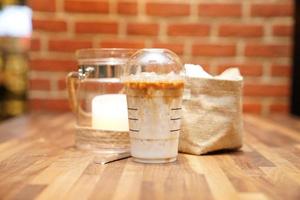 Take away Latte with Brick background on the wood table photo