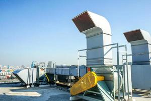 The industrial machine at the rooftop of the huge building. photo