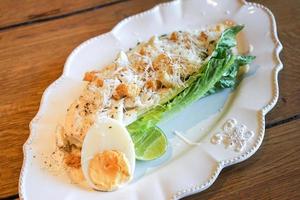 Caesar crab salad in white disk ready to searve photo