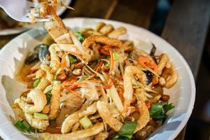 Thai food tradition style, Crispy pork spicy salad in foodtruck event. photo