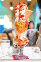 Strawberry sundae tower ice-cream with whip cream and strawberry sauce. photo