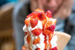 Strawberry sundae tower ice-cream with whip cream and strawberry sauce. photo