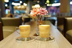 Hot Art Latte in the glass cup on the wood table photo