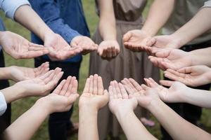 Group of Asian people raise up their right hands and handle gently to obtain and sharing good feeling to gether in Training Teambuilding. photo